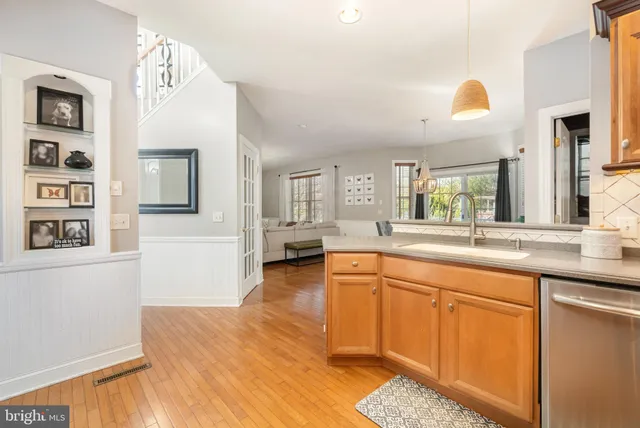 a spacious bathroom with stainless steel appliances granite countertop a sink and wooden floor