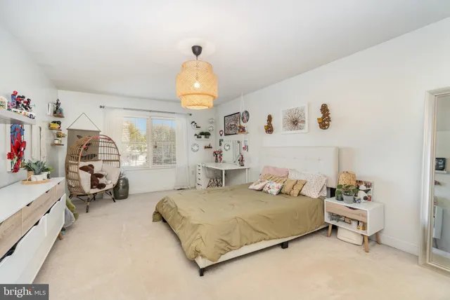 a bedroom with a bed couch and window