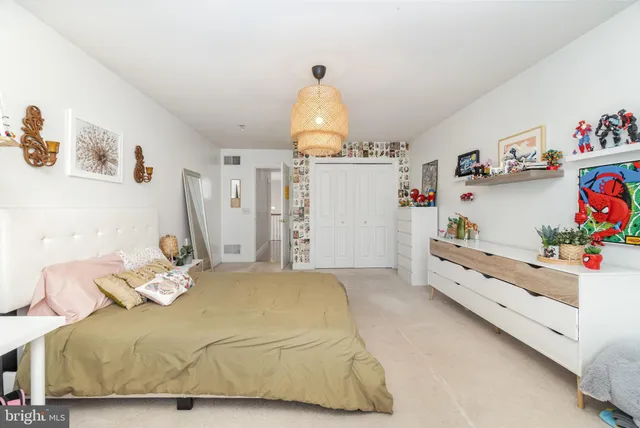 a bedroom with a bed and cabinets