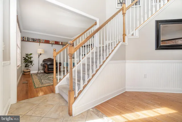 a view of staircase with railing and white walls