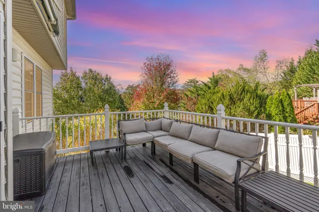a balcony with wooden floor and city view