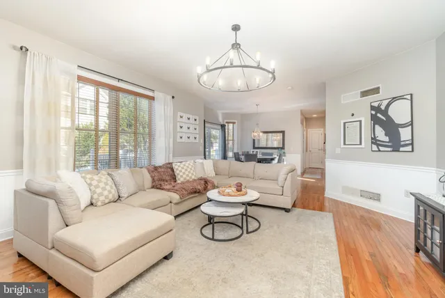 a living room with furniture a couch and wooden floor