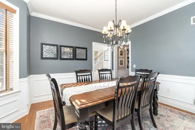 a view of a dining room with furniture and chandelier