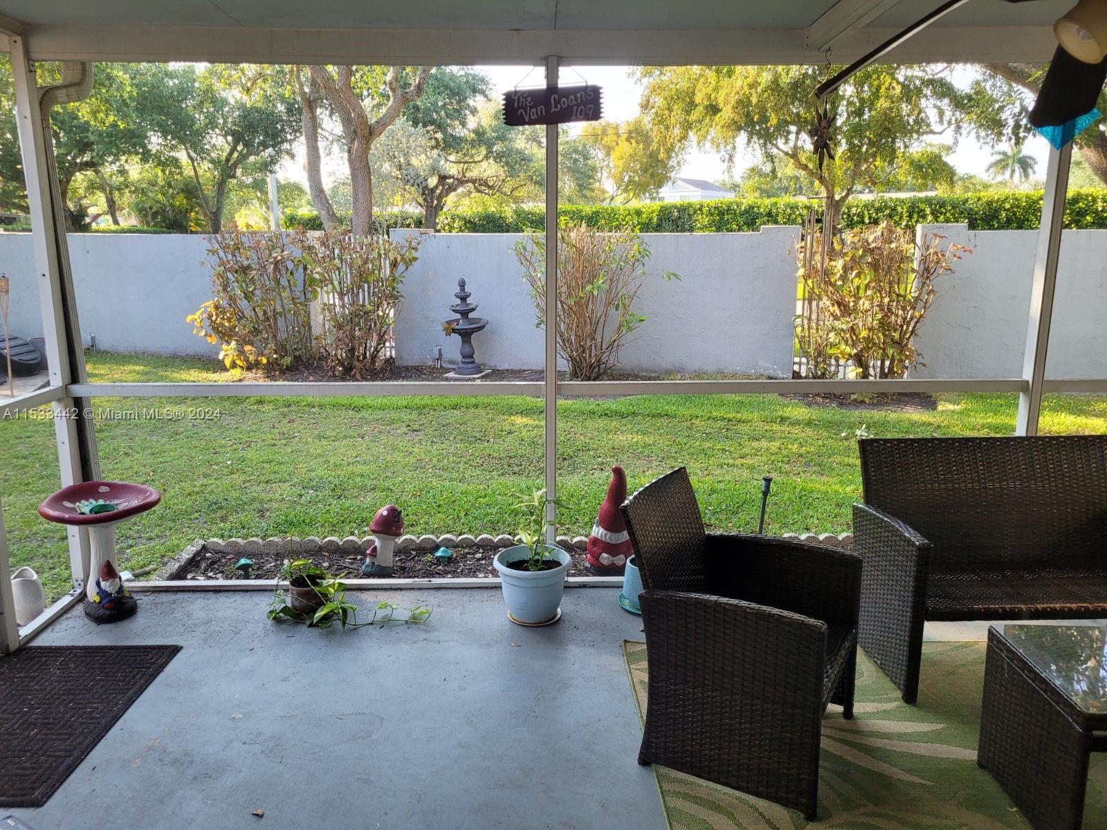 a view of a patio with table and chairs potted plants with wooden floor