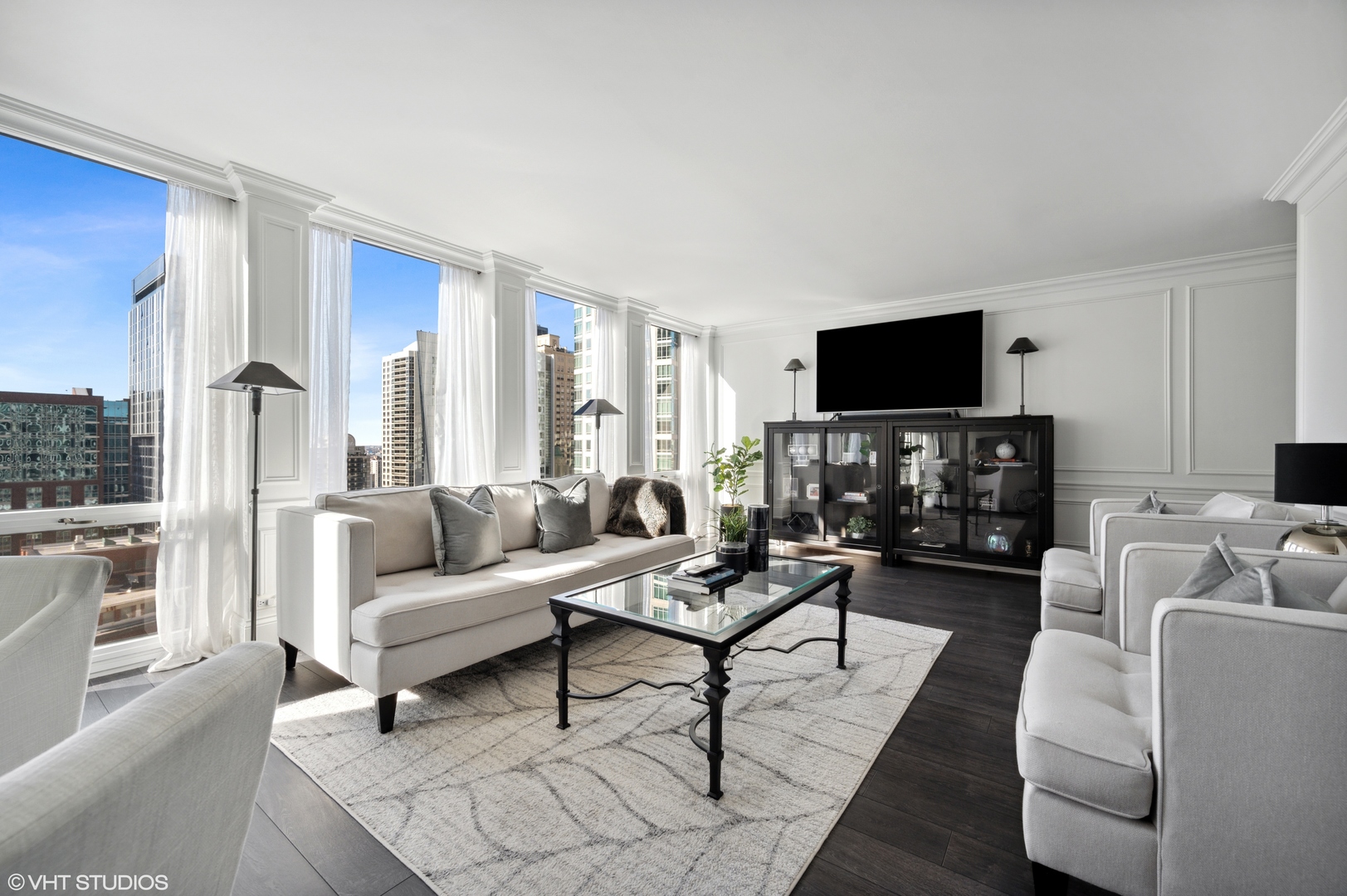 111 East Chestnut Street, Unit 26J Chicago, IL 60611 - Photo 13 of 23 a living room with furniture a flat screen tv and a fireplace