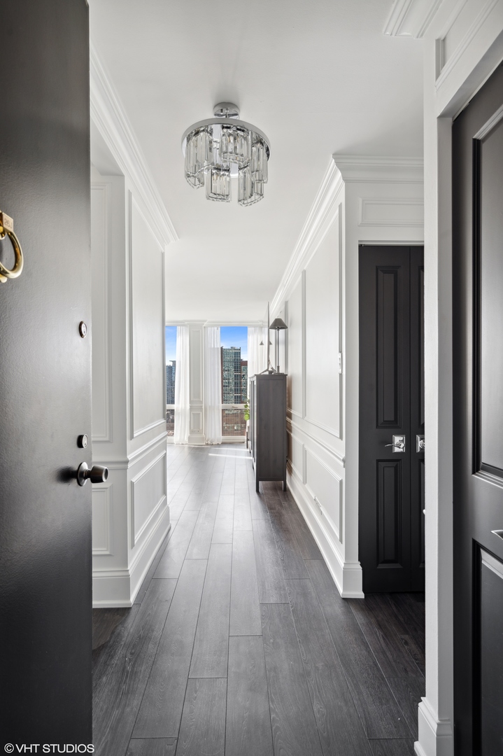 111 East Chestnut Street, Unit 26J Chicago, IL 60611 - Photo 15 of 23 a view of a hallway with a wooden floor