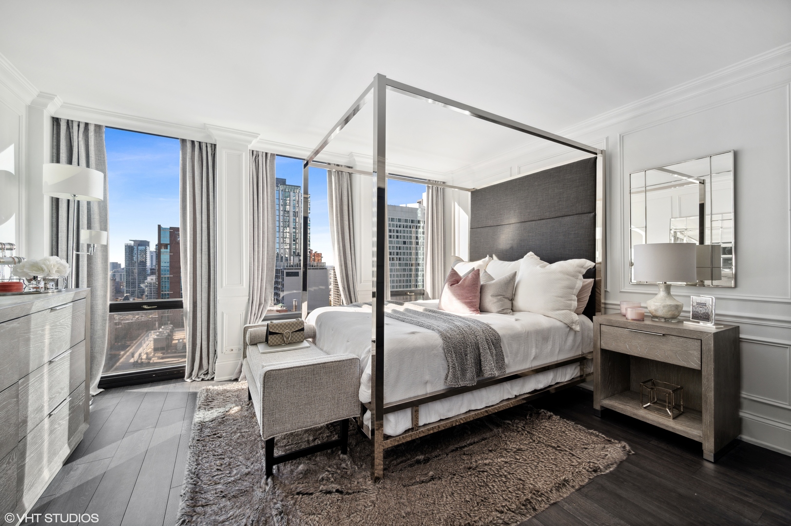 111 East Chestnut Street, Unit 26J Chicago, IL 60611 - Photo 17 of 23 a spacious bedroom with a bed and a chandelier