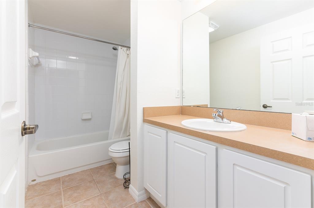 4850 Southwest 91 Terrace, Unit 301 Gainesville, FL 32608 - Photo 16 of 24 a bathroom with a granite countertop sink toilet and shower