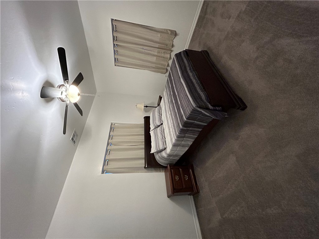2191 Seneca Street Kingman, AZ 86401 - Photo 21 of 26 a bedroom with a bed and a chandelier