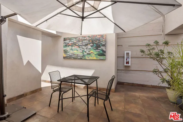 a view of a dining room with furniture and a potted plant