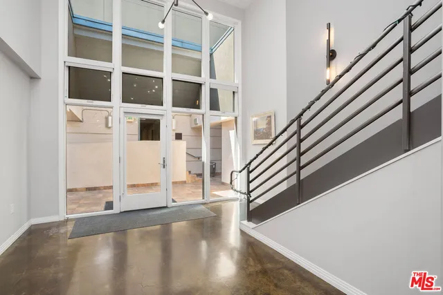 a view of a living room with wooden floor and a large window