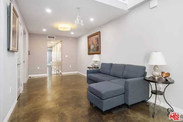a living room with furniture and a lamp