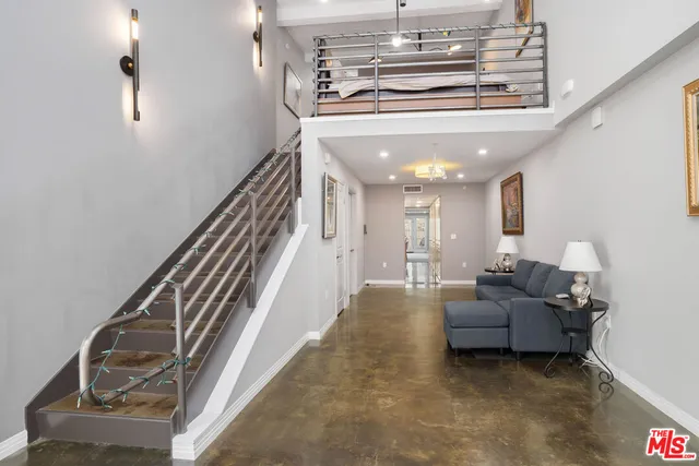 a living room with furniture and stairs