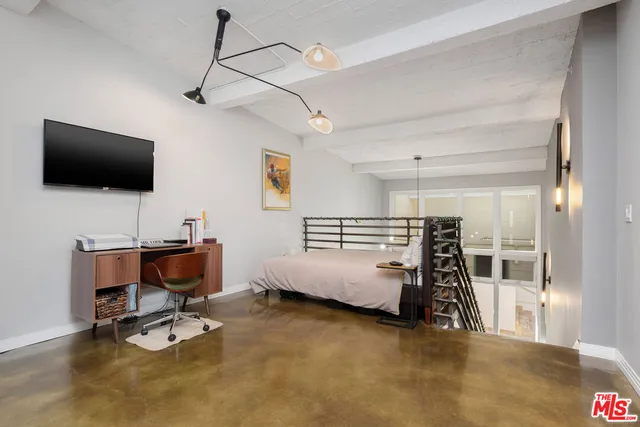 a bedroom with furniture and a flat screen tv