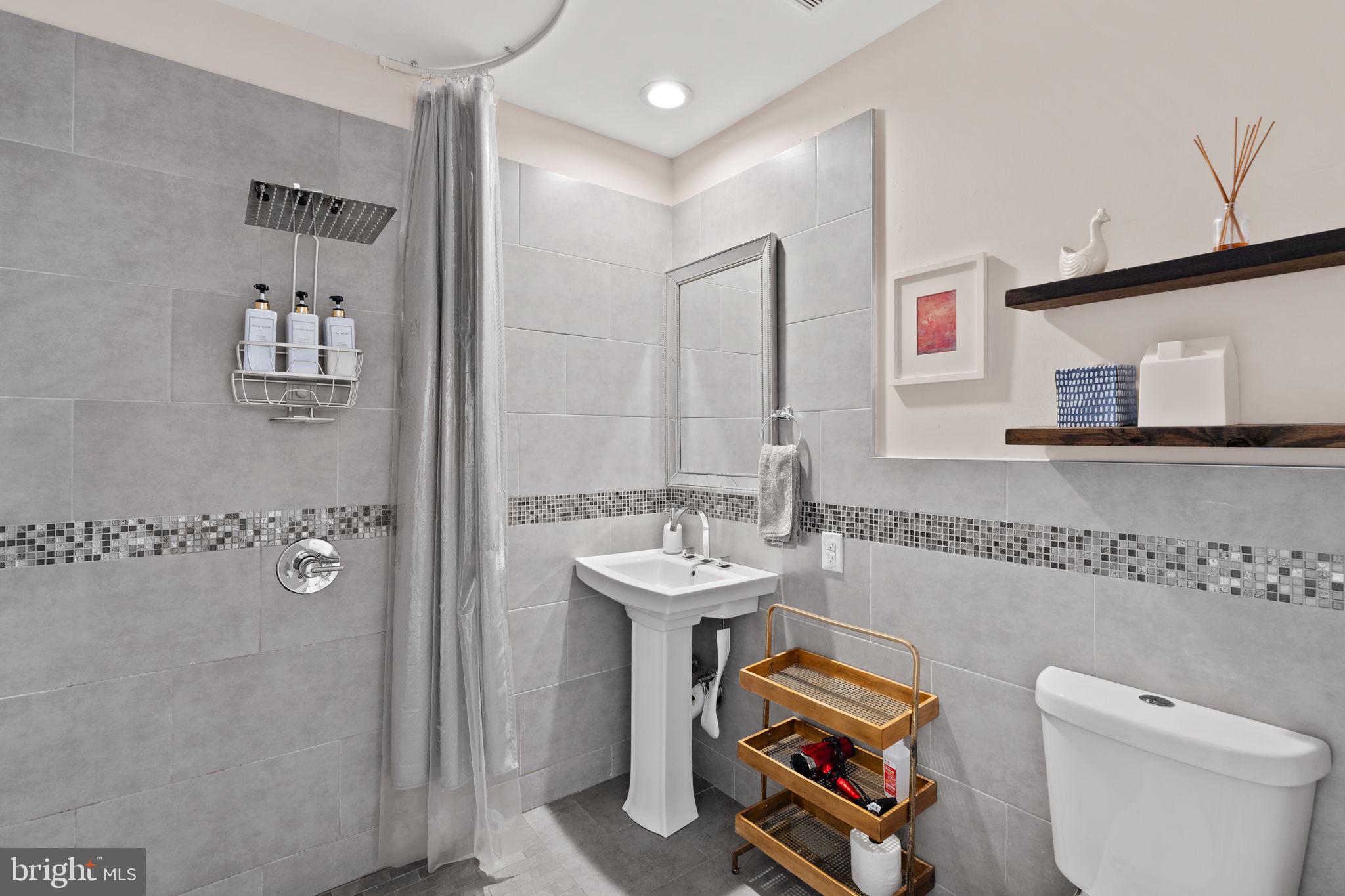 1303 Hope Street, Unit B Philadelphia, PA 19122 - Photo 11 of 16 a bathroom with a sink a toilet and shower