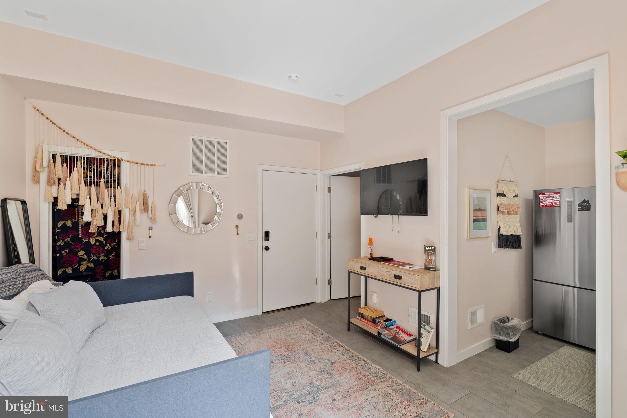 1303 Hope Street, Unit B Philadelphia, PA 19122 - Photo 4 of 16 a living room with furniture and a flat screen tv