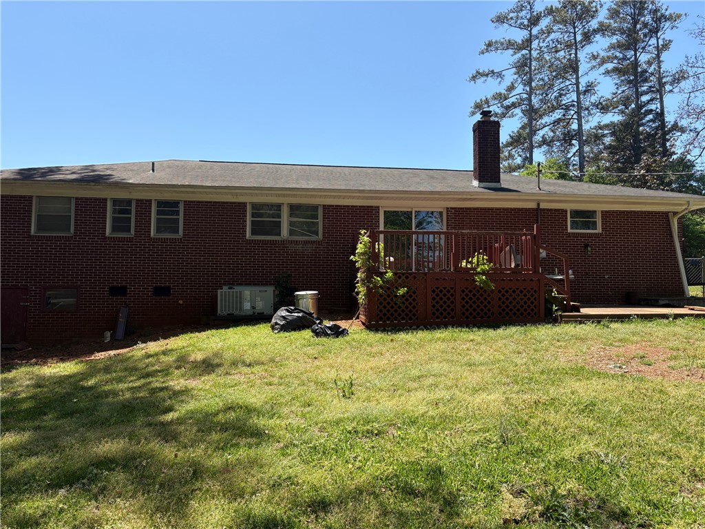 403 Brook Forest Drive Anderson, SC 29621 - Photo 17 of 18 This residence showcases a classic brick exterior with a well-maintained lawn and a welcoming deck.