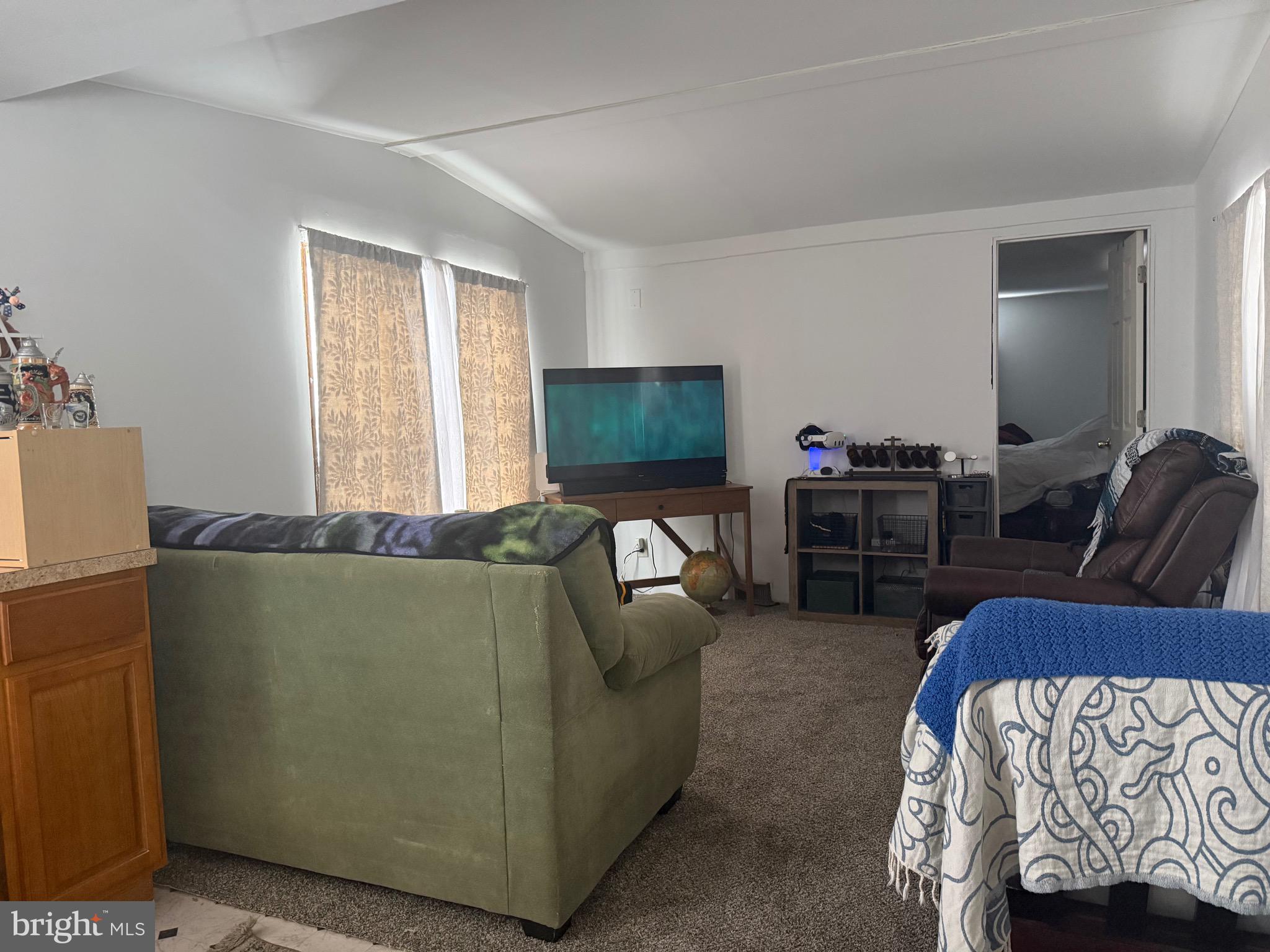 1910 Schubert Road, Unit 4 Bethel, PA 19507 - Photo 7 of 17 a living room with furniture and a flat screen tv