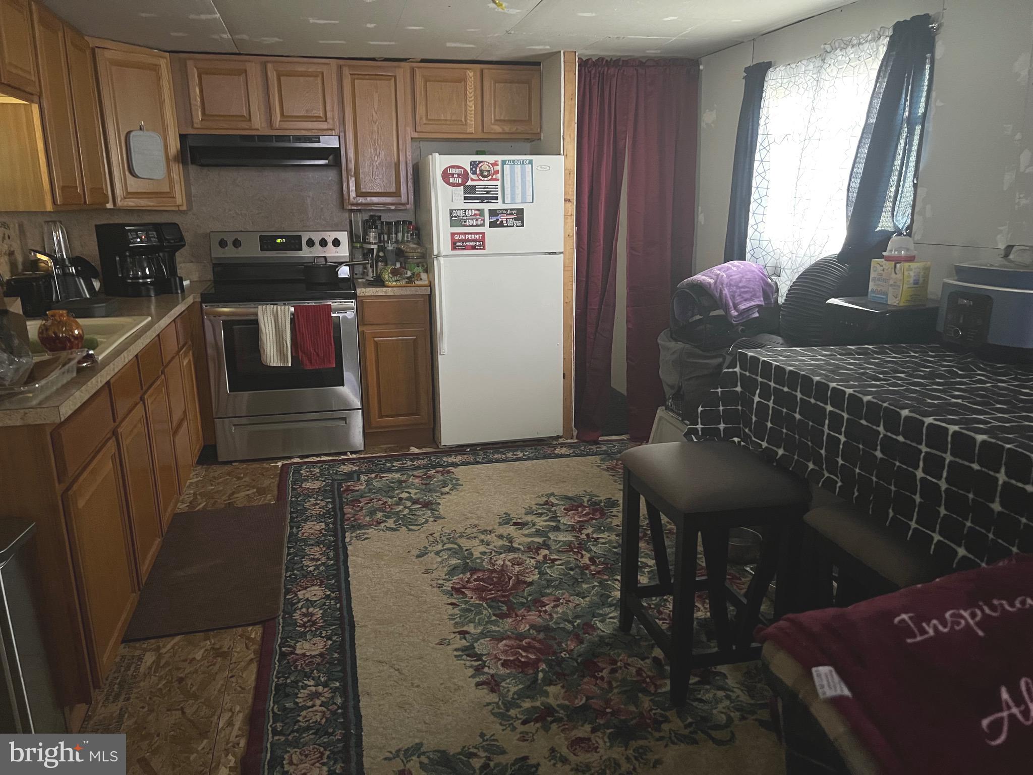 1910 Schubert Road, Unit 4 Bethel, PA 19507 - Photo 8 of 14 a kitchen with granite countertop a refrigerator stove and sink