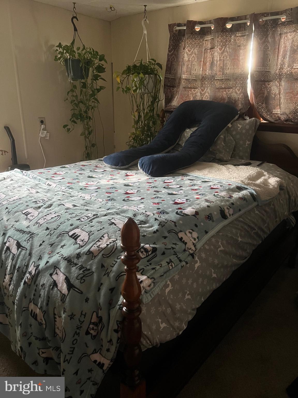 1910 Schubert Road, Unit 4 Bethel, PA 19507 - Photo 9 of 17 a bed sitting in a bedroom next to a lamp