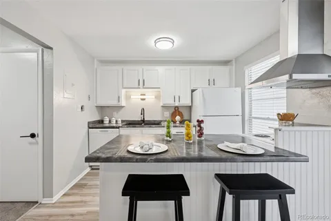 a kitchen with refrigerator and stove
