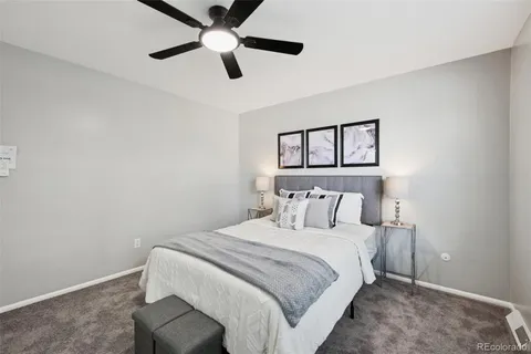 a bedroom with a bed and a painting on the wall