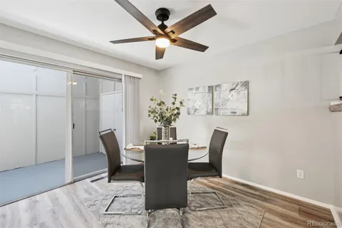 a view of a dining room with furniture and a chandelier fan