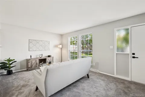 a living room with furniture and large window