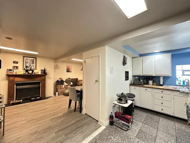 a kitchen with a refrigerator and a stove top oven