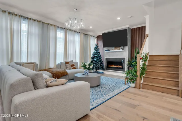 a living room with furniture fireplace and potted plant
