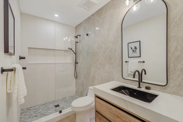 a hotel room with two bed and a flat screen tv