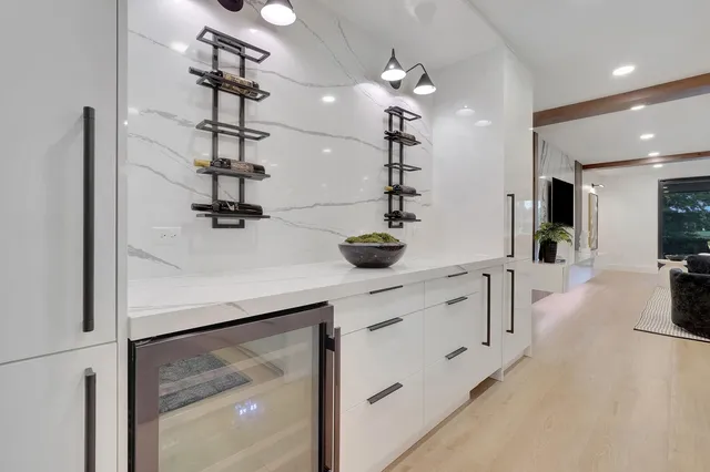 a kitchen with sink refrigerator and large window