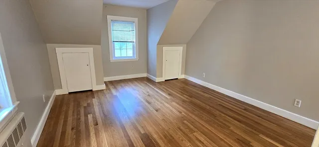 a view of a room with wooden floor and window