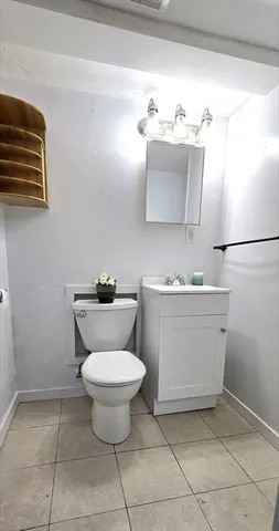 a bathroom with a sink toilet and mirror