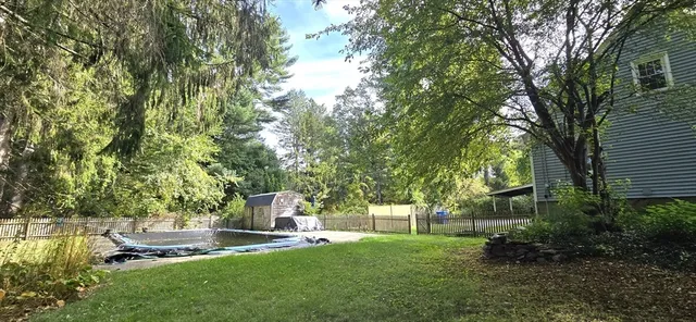 a backyard of a house with table and chairs