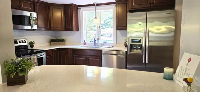 a kitchen with a refrigerator and a sink