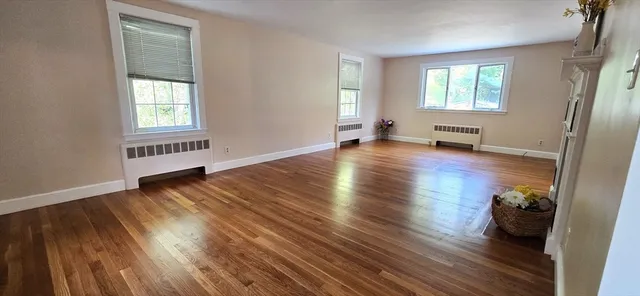 a view of a livingroom with hardwood floor and a window