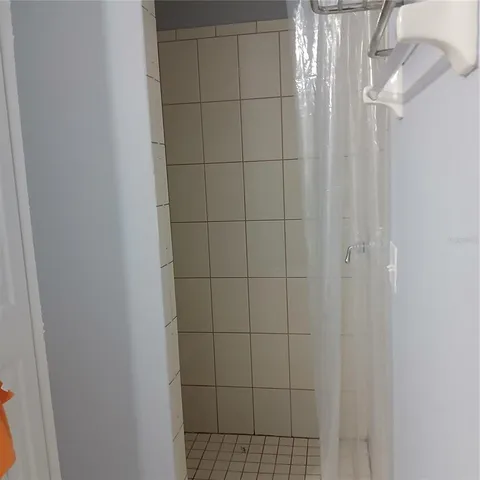 a view of a bathroom with wooden floor