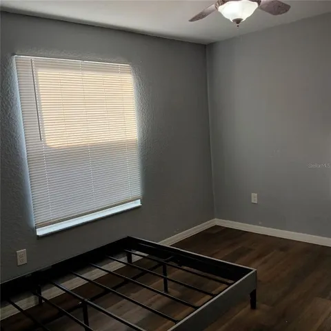 a view of a room with wooden floor and window