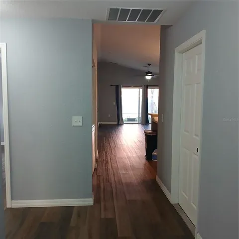 a view of hallway with wooden floor