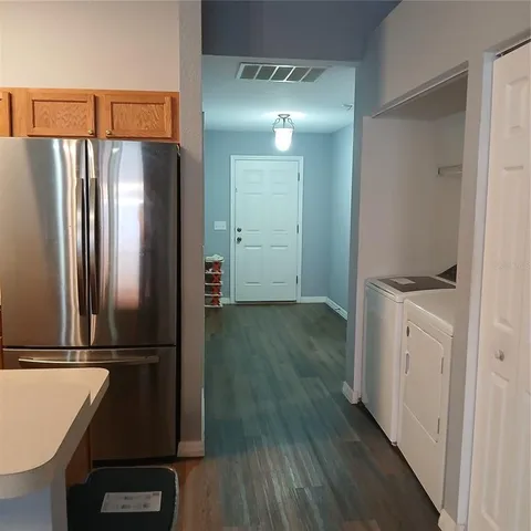 a kitchen with a refrigerator and a stove top oven
