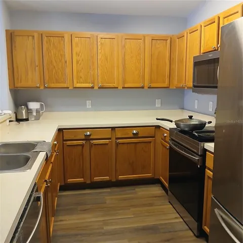a kitchen with wooden cabinets and a stove top oven