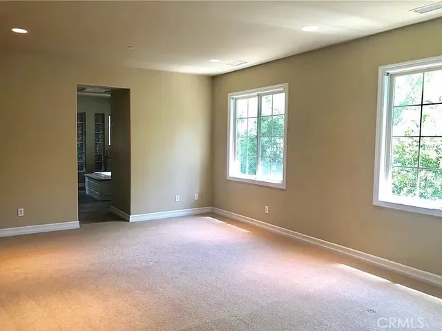 an empty room with windows and closet