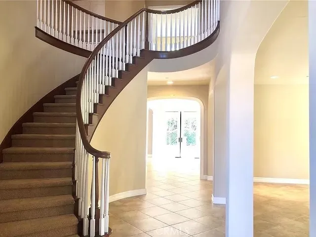 a view of staircase with wooden floor and a potted plant