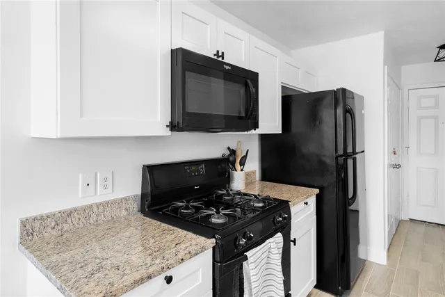 a kitchen with stainless steel appliances granite countertop a refrigerator stove and microwave