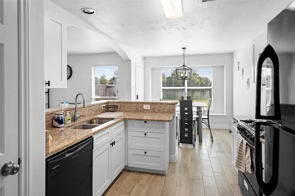 a kitchen with a table chairs refrigerator and cabinets