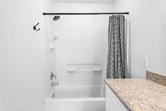 a bathroom with a bath tub and shower