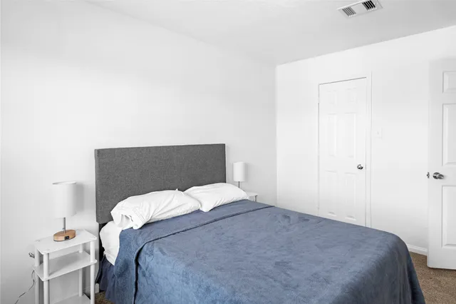 a bedroom with a bed and a table