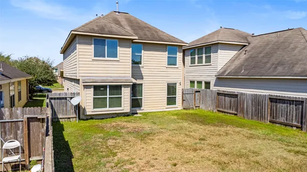 a view of a house with a yard and sitting area
