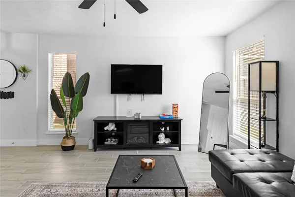 a living room with furniture and a flat screen tv